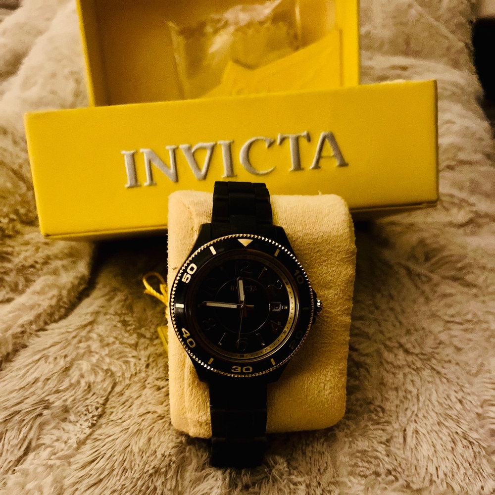 Women’s black and gold Invicta watch